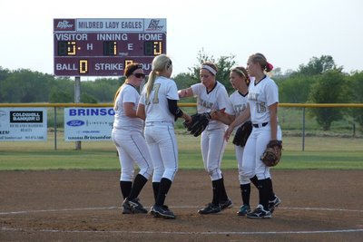 Image: The Lady Gladiator infielders meet at the mound to start the game.