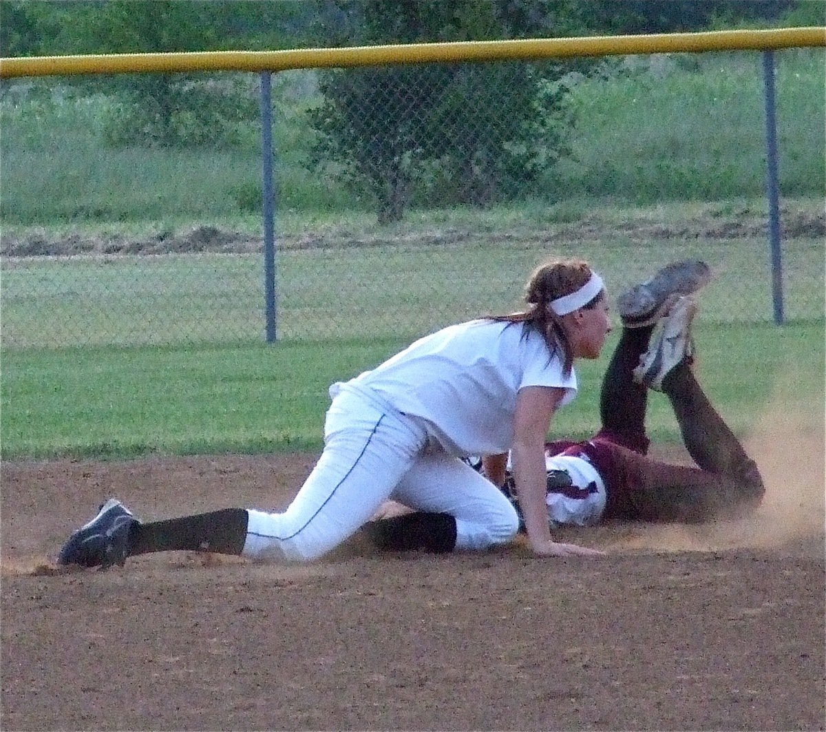Image: Bailey Bumpus, also a senior Lady Gladiator, tries to make a tag for an out at second base.