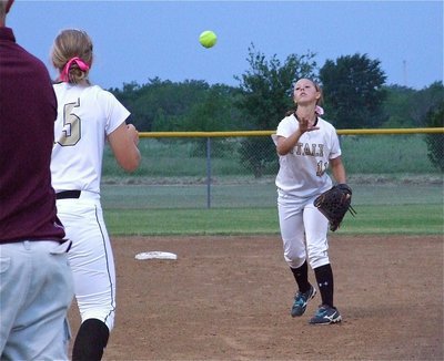 Image: Lady Gladiator second baseman, Bailey Eubank(11) softly tosses a ball to teammate, Jaclynn Lewis(15), for an out.