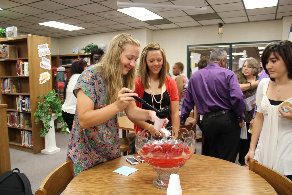 Image: Jaclynn Lewis (freshman) and Bailey Eubank (freshman) serve refreshments.