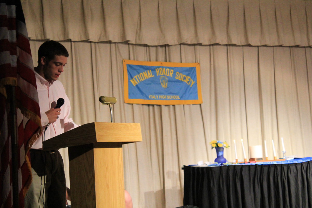 Image: Brandon Souder (senior) reads the “Service” NHS guidlines.