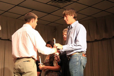 Image: Treasurer, Brandon Souder (Senior) hands his flame on to Cole Hopkins (junior).