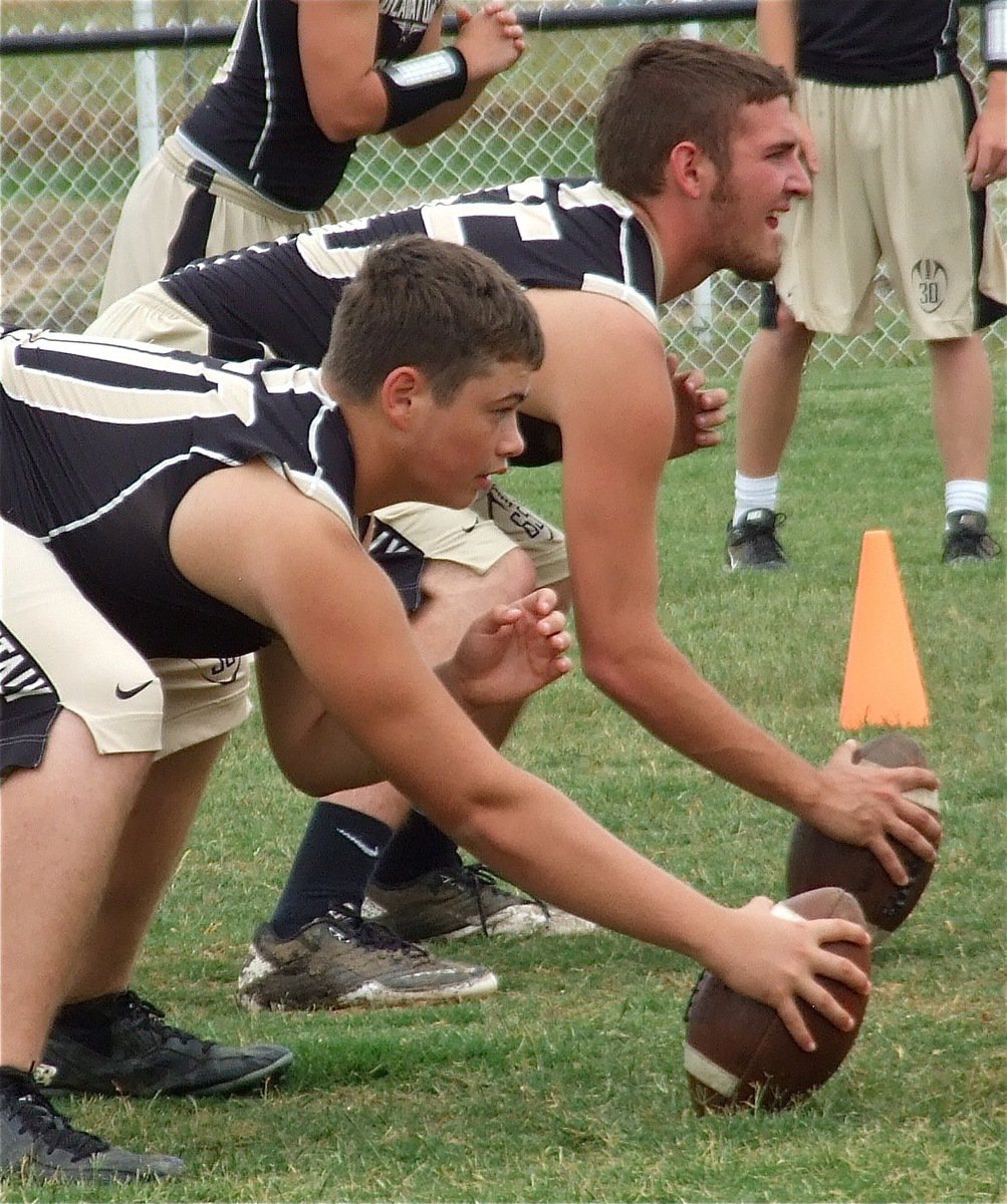 Image: Zain Byers(50) and Zackery Boykin(55) work on snaps.