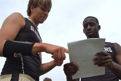 Image: Cole Hokins and Marvin Cox glance at the play sheet.