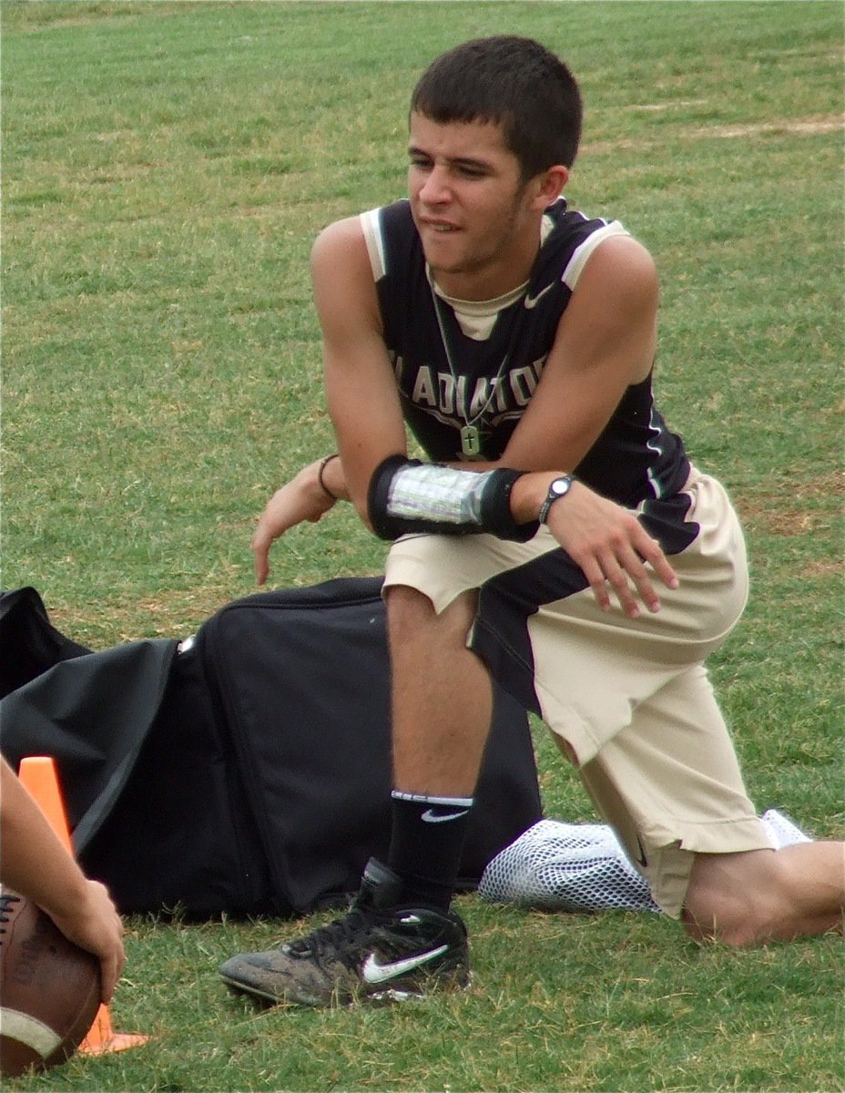 Image: Caden Jacinto helps supply the centers with footballs.