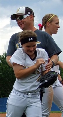 Image: Congratulating Tara Wallis(8) on making the catch in left field is Lady Gladiator assistant softball coach, Michael Chambers.