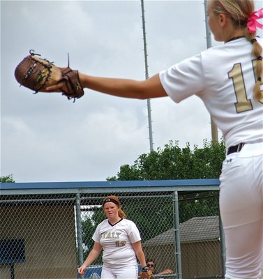 Image: Third baseman, Katie Byers(13) throws to first baseman, Jaclynn Lewis(15) for an out.