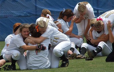 Image: Seniors Alma Suaste, Bailey Bumpus and Megan Richards receive hugs from teammates during the team’s final huddle.