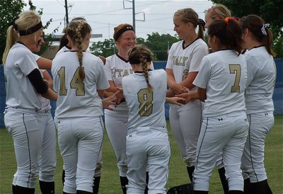 Image: The Lady Gladiators share a moment before the start of game 2 in the regional quarterfinal against Crawford.