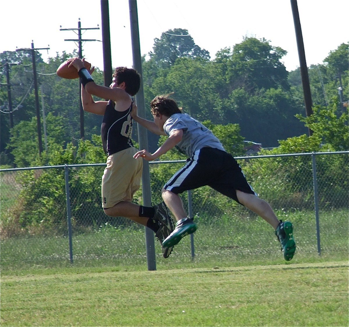 Image: Tyler Anderson runs a crossing route and leaps for a touchdown catch during JV action.