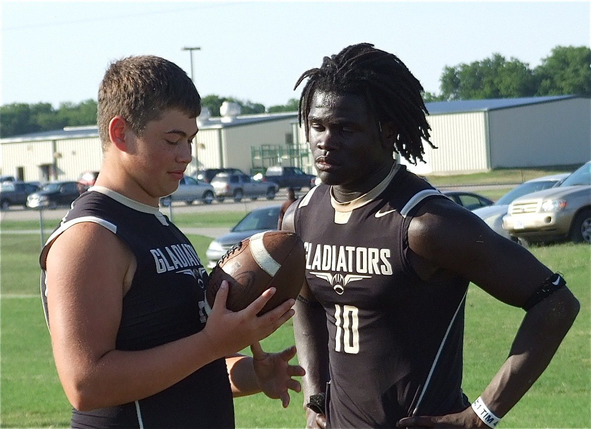 Image: Zain Byers and Ryheem Walker talk football during a break in the action.