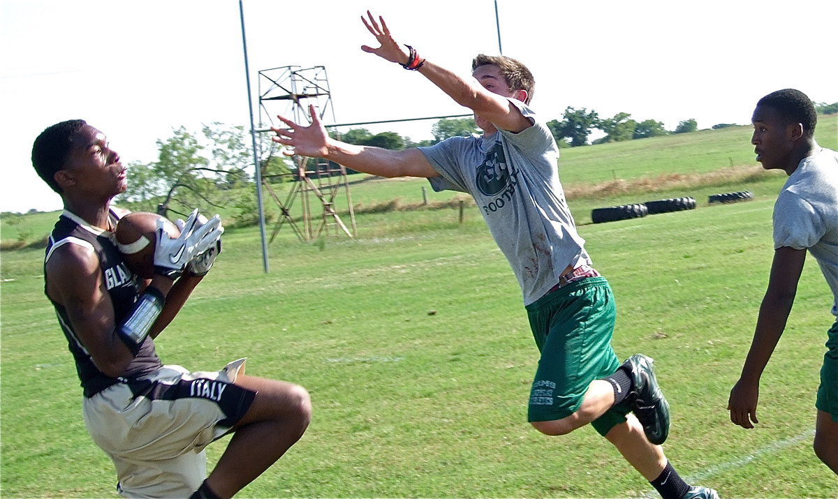 Image: Trevon Robertson cradles in a pass from Marvin Cox.