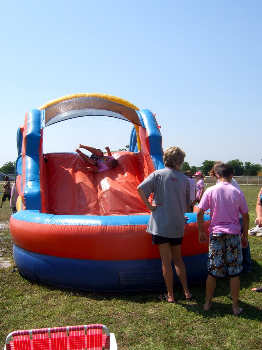 Image: He is trying to go down the slide upside down.