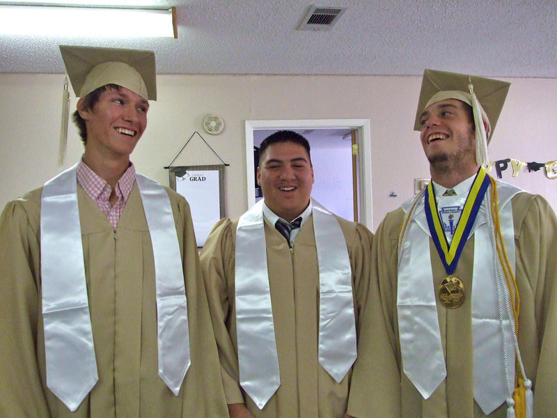 Image: Alex DeMoss, Isaac Medrano and Brandon Souder get ready for the Baccalaureate services at First Baptist Church on Sunday.