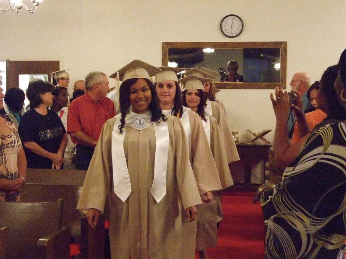 Image: Here come the graduates to the march Pomp and Circumstance.