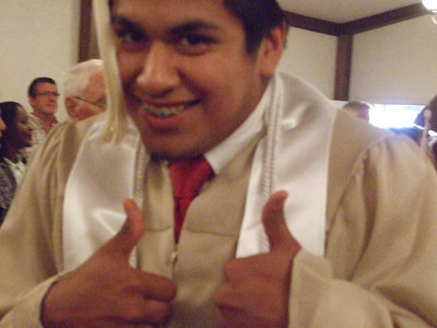 Image: Omar Estrada gives “thumbs up” for graduation.