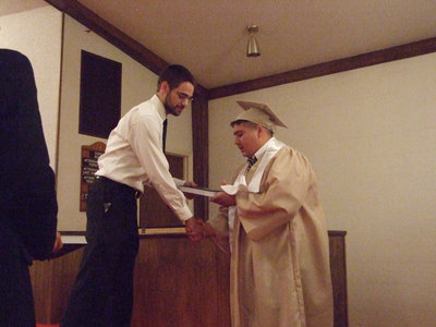 Image: Isaac Medrano also receives a Bible.