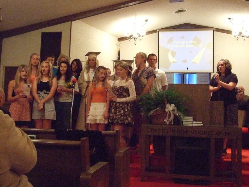 Image: The youth from First Baptist Church along with leader, Amber Droll, offered song as a gift for the graduating class.