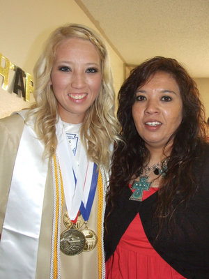 Image: Class Valedictorian, Megan Richards and mom, Tina, take a moment for a picture afterwards.