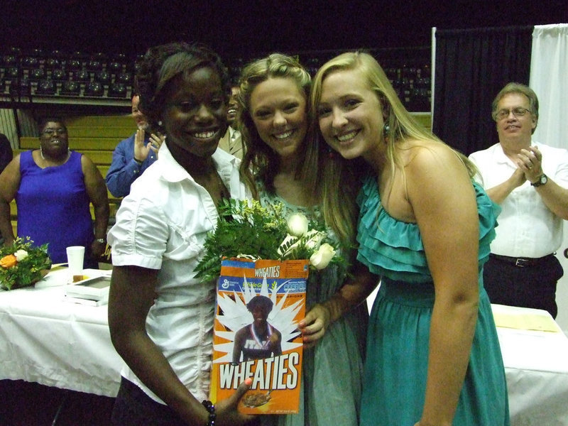 Image: Jaclynn Lewis and Bailey Eubank, on behalf of the freshman class, presented classmate Kortnei Johnson with her own Wheaties box.  Kortnei competed in the state track competition, winning 1st, 2nd and 4th (in 100m dash, 200m dash and long jump respectively).
