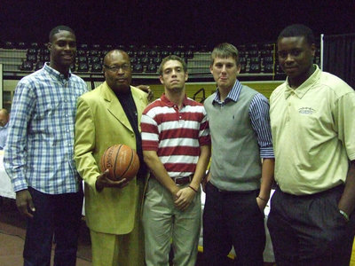 Image: Coach Larry Mayberry was awarded a ball by the senior team members.