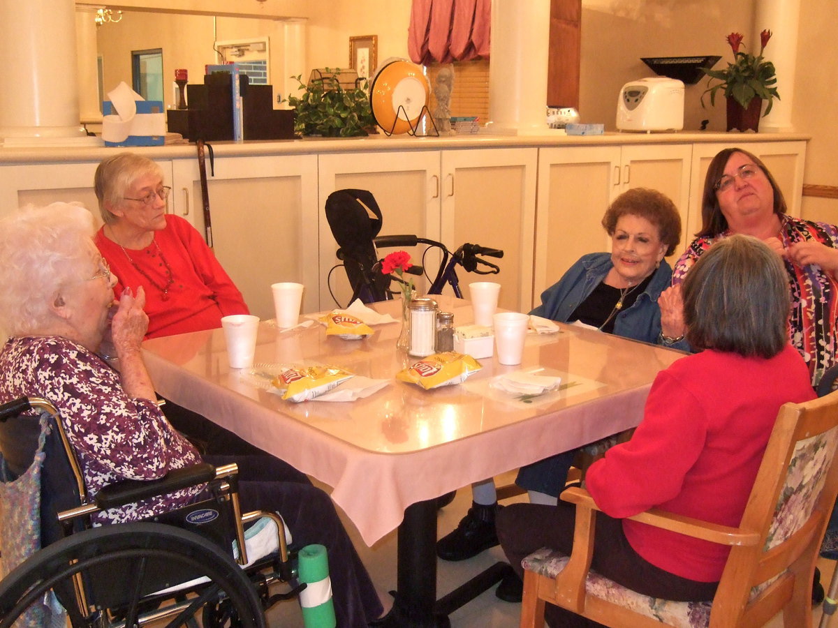 Image: These residents are enjoying the birthday celebration.