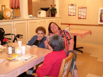 Image: Carolyn Powell (activities director) having fun with the residents.
