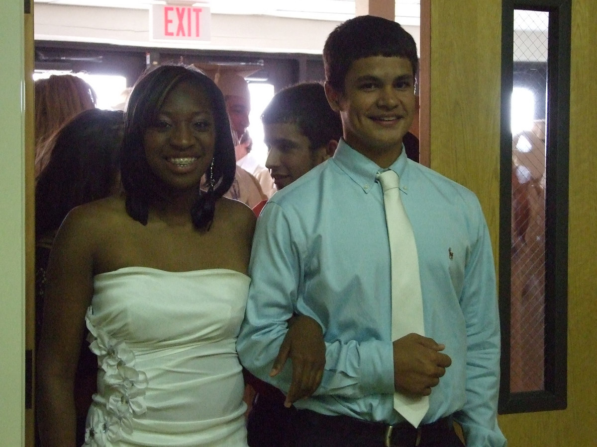 Image: Jimeka Copeland and Reid Jacinto escort the seniors to their seats.  Katie Byers, Chase Hamilton, Caden Jacinto and Alyssa Richards also helped with seating.