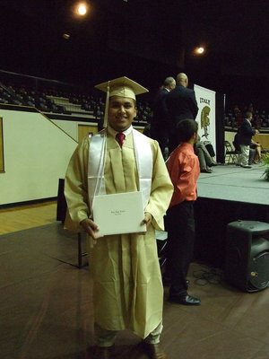 Image: Omar Estrada graduates with a smile.