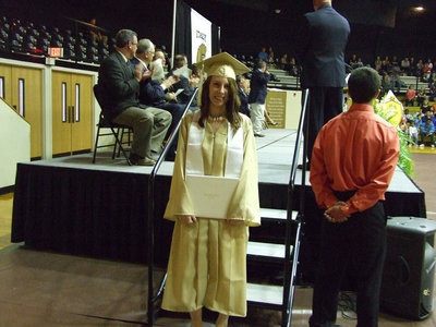 Image: Holli Love takes time for a photo during graduation.