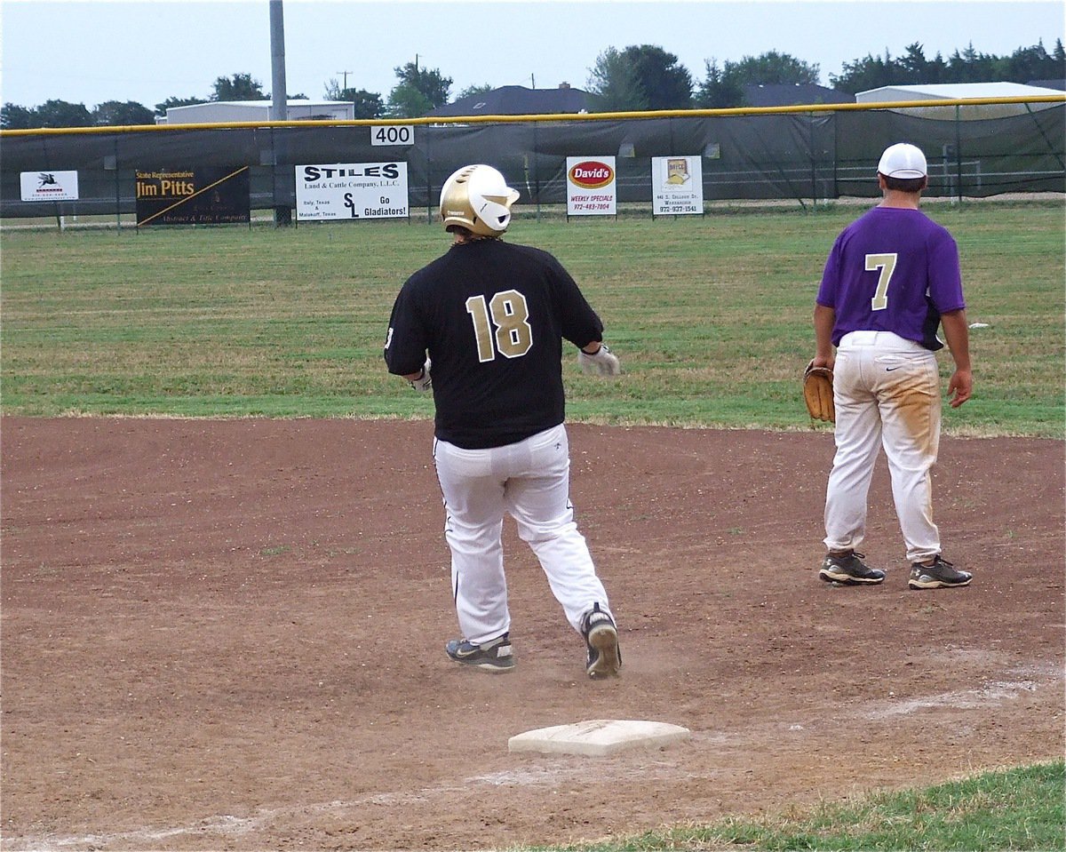 Image: Gladiator sophomore John Byers(18) turns and looks after dropping a single into right field.