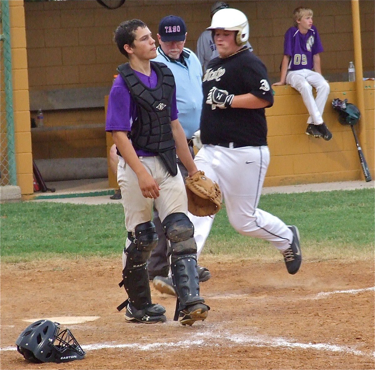 Image: John Byers(18) reaches home plate for an Italy run.