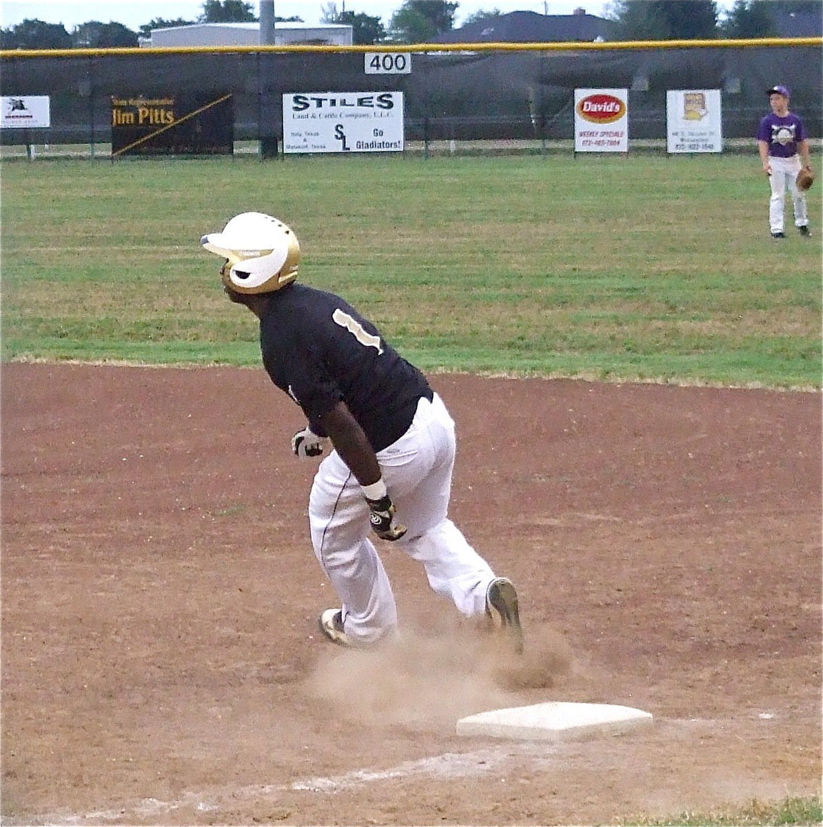 Image: Italy’s Marvin Cox(1) turns and looks after hitting a single.