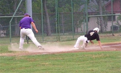 Image: Justin Wood(4) slides safely into third base.