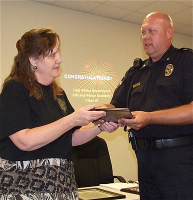 Image: Meg Lyons presents Italy Police Chief Diron Hill with a gift of appreciation for his and his officers’ efforts in the Citizens Police Academy.