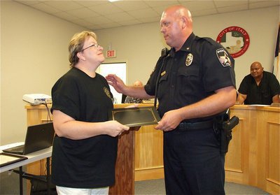 Image: Anne Sutherland is beaming with pride upon receiving her diploma and congratulations from Chief Hill as a member of the first class of graduates from the Citizens Police Academy.