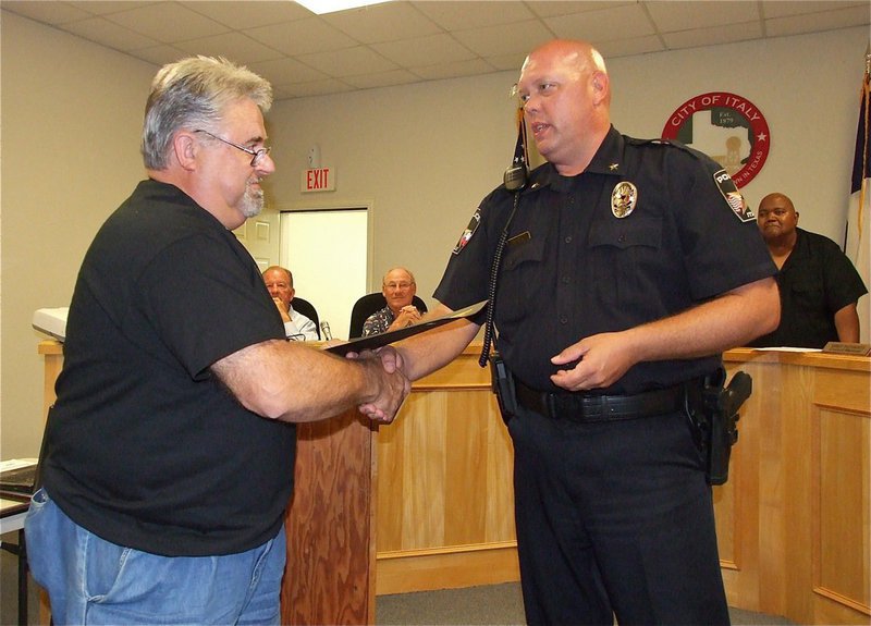 Image: James “J.D.” Doskocil is congratulated by Italy Police Chief Diron Hill on being a member of the first training class of the Citizens Police Academy.