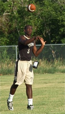 Image: Gladiator 7-on-7 quarterback Marvin Cox launches a pass downfield.