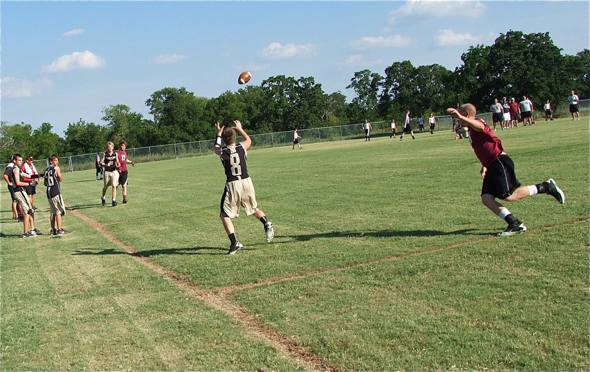 Image: Breaking off his pass pattern to make a sideline grab is Italy’s John Escamilla(8).