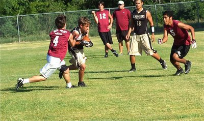 Image: Italy’s Levi McBride makes a reception between Riesel defenders.