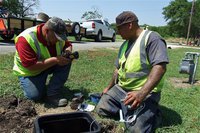 Image: RG3 Utility foreman, Charlie Bateman, and fellow crewman, Alfredo Bolado, Jr., prepare to set the sensor that will communicate via satellite on a newly installed Smart Meter. The system will allow Italy City Hall to regulate water flow for billing purposes, as well as, being alerted to potential property leaks within the city grid.