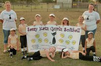 Image: The Italy’s Sassy Katz Gurlz Softball team displays their team banner while parents Shauna Butler and Melissa Shelby pose in their Sassy Katz fan gear!