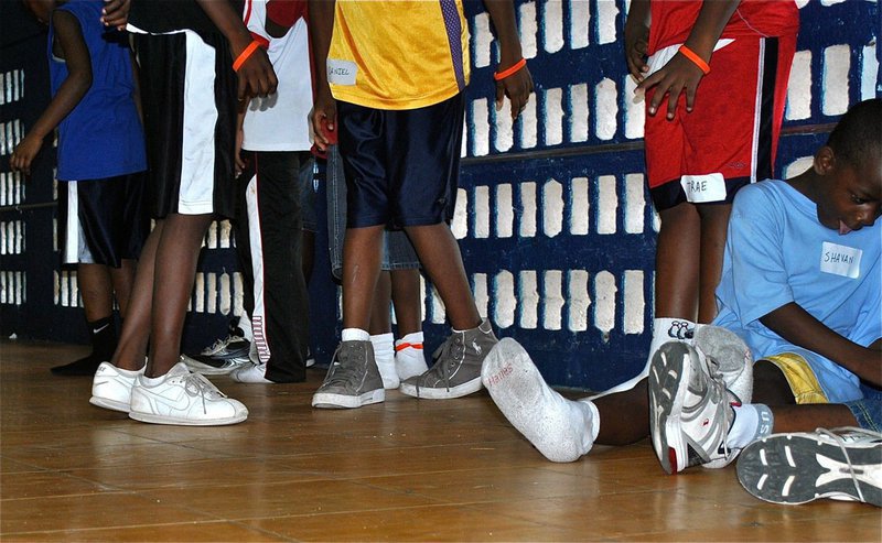 Image: Many of the Basketball Smile campers are unable to afford tennis shoes therefore they come to camp in socks.
    This age youth’s feet grow very quickly, and their need for new shoes is a yearly event which is just something that these kids’ families cannot afford.