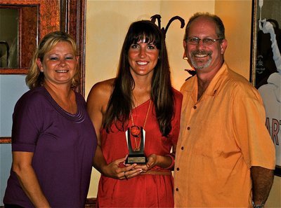 Image: Have A Heart Of Gold Will Travel: Local Nassau Rotarians present Megann Mae Lewis Harlow, a Lady Gladiator at Italy High School from 2003 to 2007, with her Basketball Smiles coaching trophy.