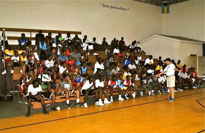 Image: Event founder, Sam Nichols, gives Basketball Smiles campers hope for a brighter future both athletically and academically.