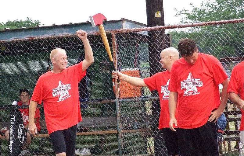 Image: Earl “Red” Buchanan taps the Italy Fire Department’s battle axe, held by Michael Chambers, to help create some team mojo.