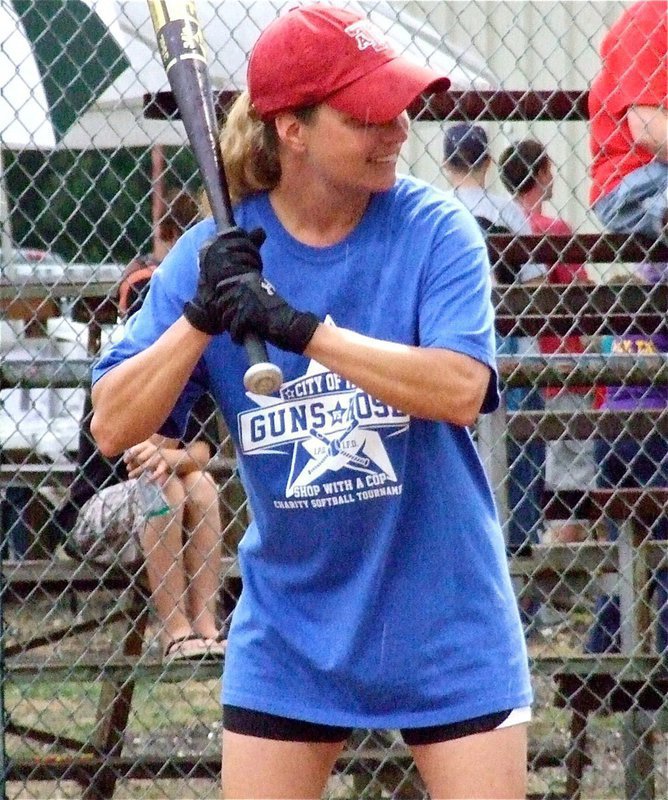 Image: I.P.D.s Sergeant Tierra Mooney takes a turn at bat with the rain drops pouring down. 