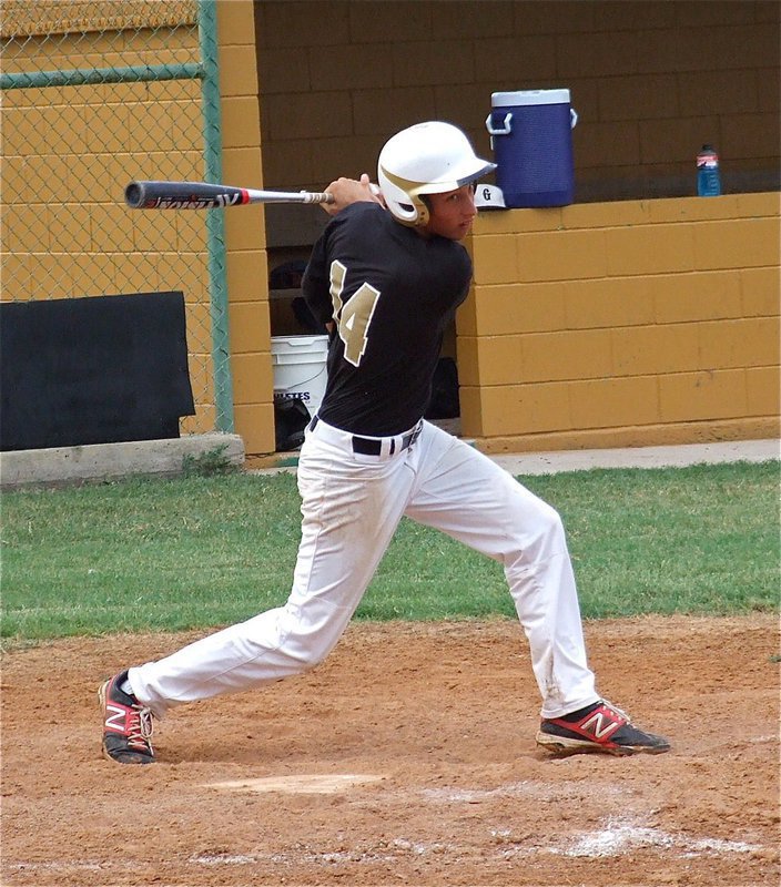 Image: Brett Pickard sends a shot down the first base line.