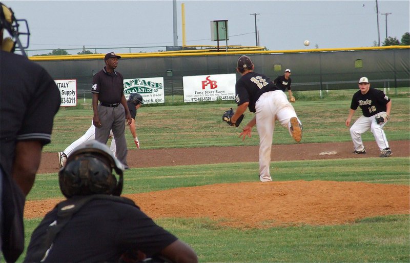 Image: Pitcher Tyler Anderson(11) tries to catch a Zebra runner too far off the second base bag with teammate John Byers covering and Brett Pickard backing up the play in center field.