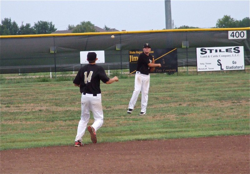 Image: Zackery Boykin(12) throws the ball in to Brett Pickard(20) after a Grandview hit in game two.